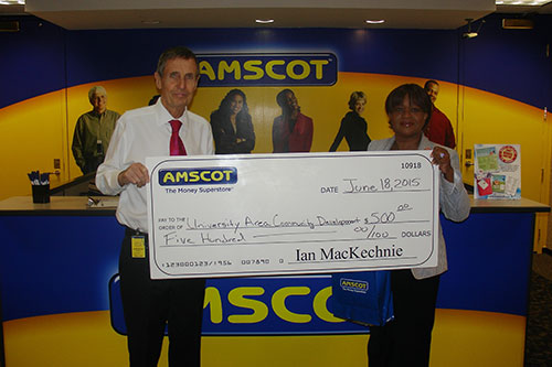 Ian MacKechnie presents donation to Community Development